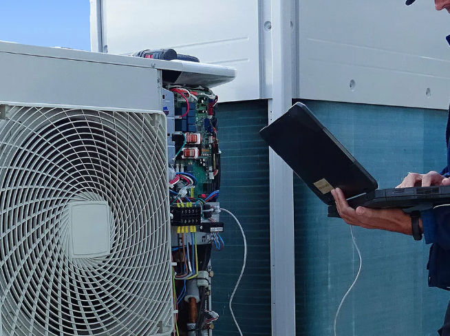 Technician performing HVAC diagnostic with thermal camera